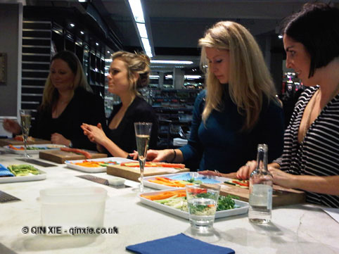 Group making rice paper rolls