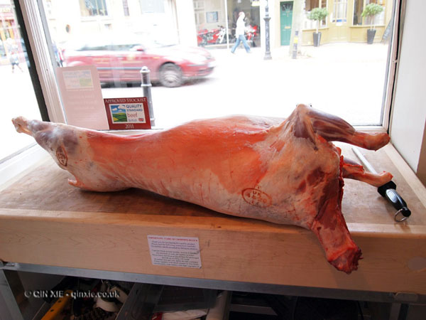 A whole lamb carcass on butcher's block