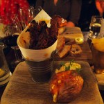 Bucket of ribs with cheddar baked potato, apple slaw and chips at Fox and Anchor, Clerkenwell
