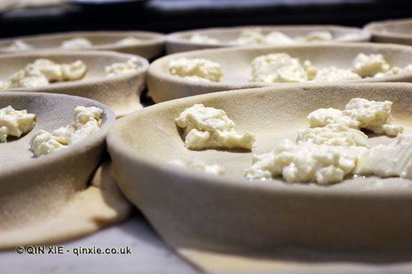 Focaccia with cheese in the making, Restaurante i Tre Merli Porto Antico, Genoa